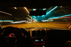 Image depicting a car being driven with the landscape blurred as if the driver is drunk